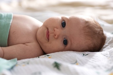 Photo of Cute newborn baby lying on bed, closeup
