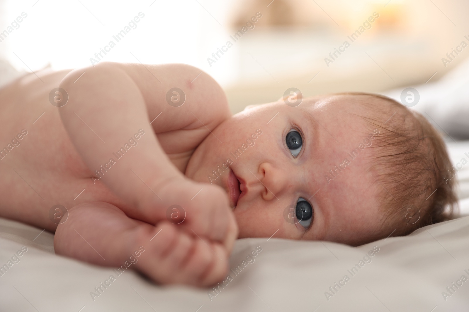 Cute newborn baby lying on bed, closeup Photo of Cute newborn baby lying on bed, closeup