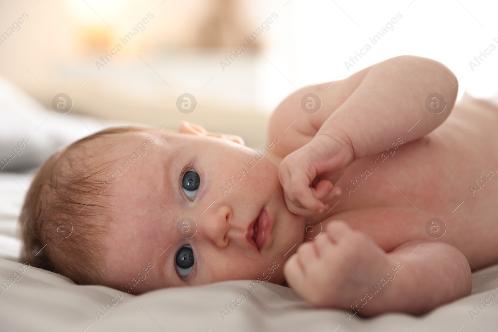 Cute newborn baby lying on bed, closeup Photo of Cute newborn baby lying on bed, closeup