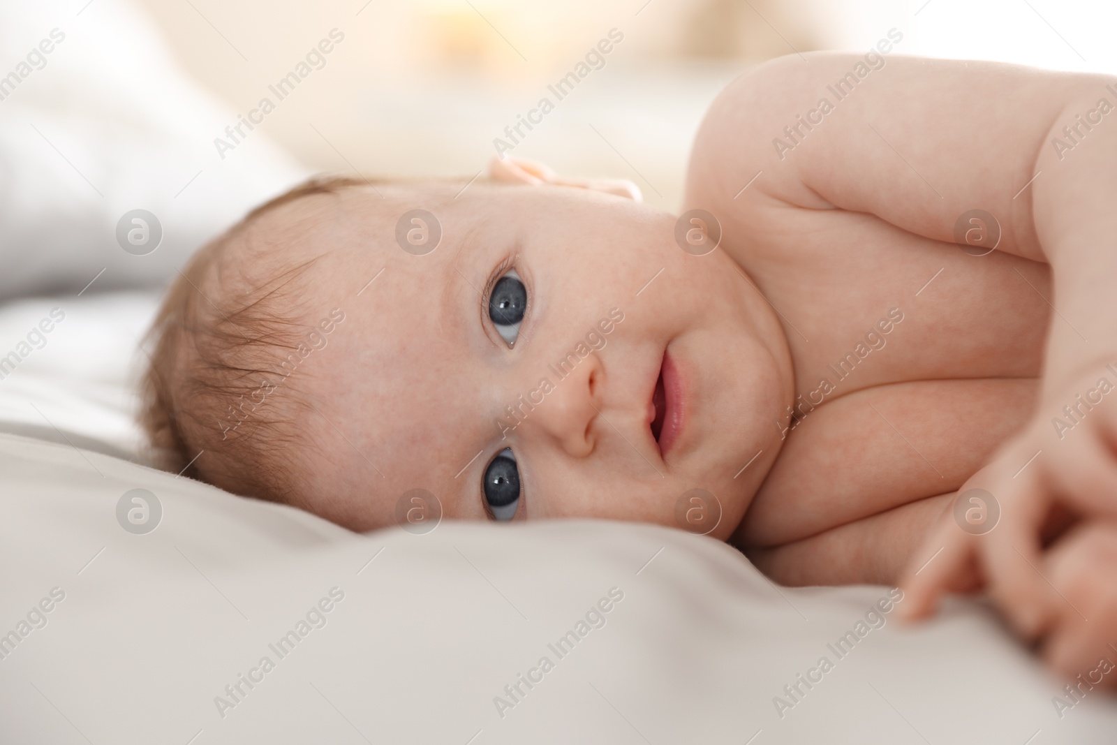 Cute newborn baby lying on bed, closeup Photo of Cute newborn baby lying on bed, closeup
