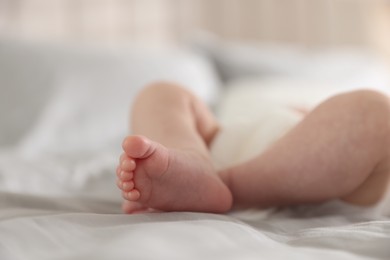 Photo of Cute newborn baby lying on bed, closeup