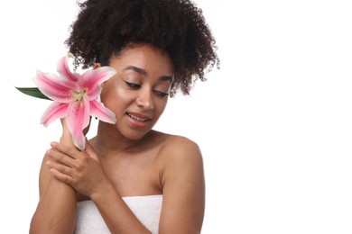Photo of Portrait of beautiful Brazilian woman with lily flower after spa treatment on white background