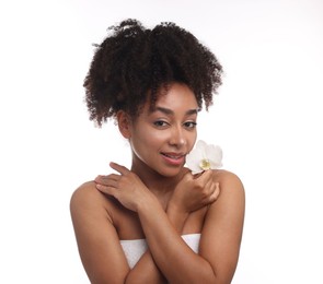 Photo of Portrait of beautiful Brazilian woman with orchid flower after spa treatment on white background
