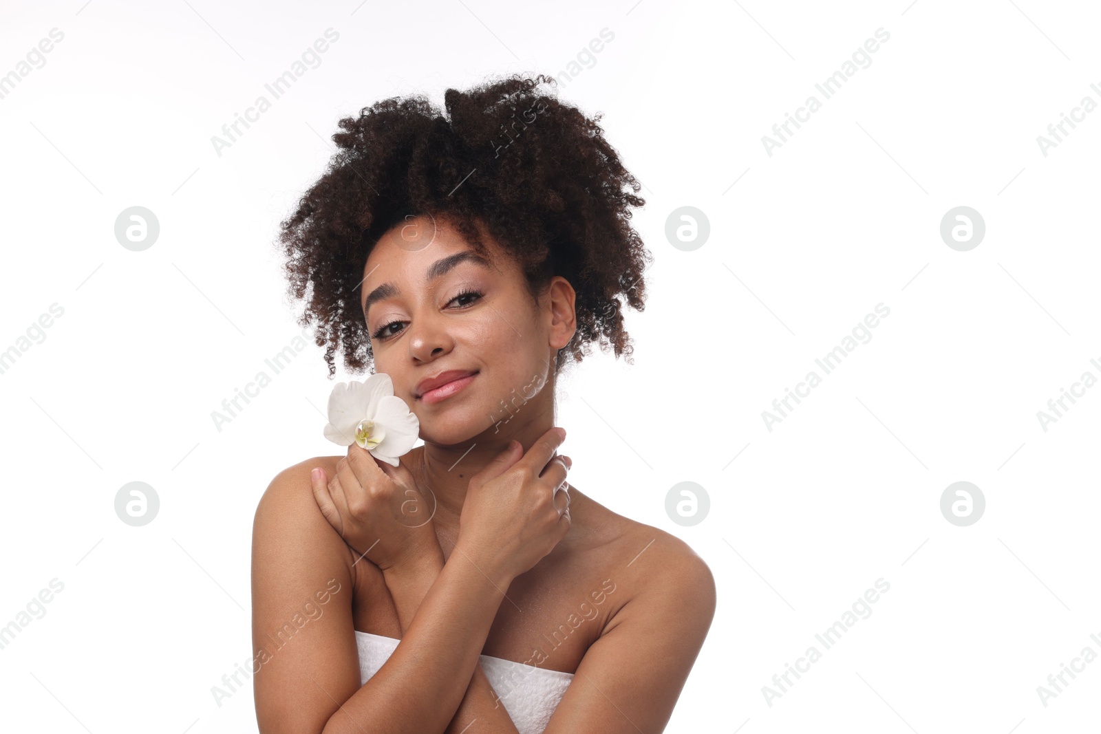 Portrait of beautiful Brazilian woman with orchid flower after spa treatment on white background Photo of Portrait of beautiful Brazilian woman with orchid flower after spa treatment on white background