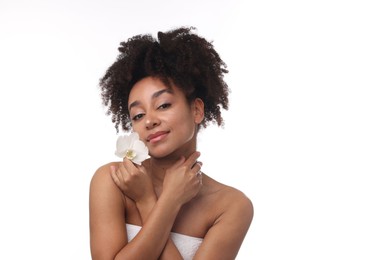 Photo of Portrait of beautiful Brazilian woman with orchid flower after spa treatment on white background