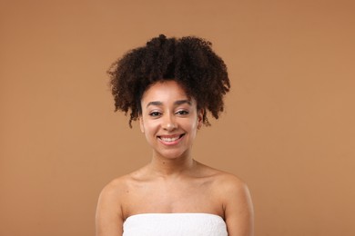 Photo of Portrait of beautiful Brazilian woman after spa treatment on light brown background