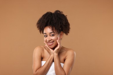 Photo of Portrait of beautiful Brazilian woman after spa treatment on light brown background