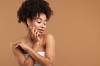 Photo of Portrait of beautiful Brazilian woman after spa treatment on light brown background. Space for text