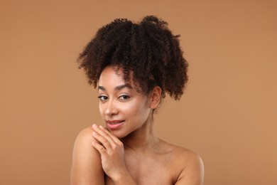 Photo of Portrait of beautiful Brazilian woman after spa treatment on light brown background
