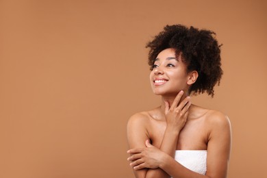Photo of Portrait of beautiful Brazilian woman after spa treatment on light brown background. Space for text