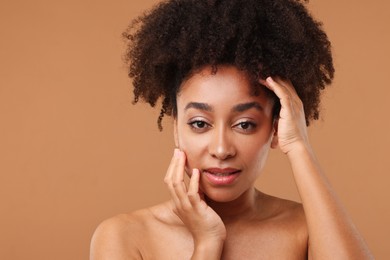 Photo of Portrait of beautiful Brazilian woman after spa treatment on light brown background