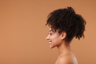 Photo of Portrait of beautiful Brazilian woman after spa treatment on light brown background. Space for text