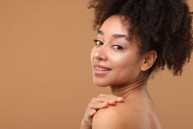 Photo of Portrait of beautiful Brazilian woman after spa treatment on light brown background. Space for text