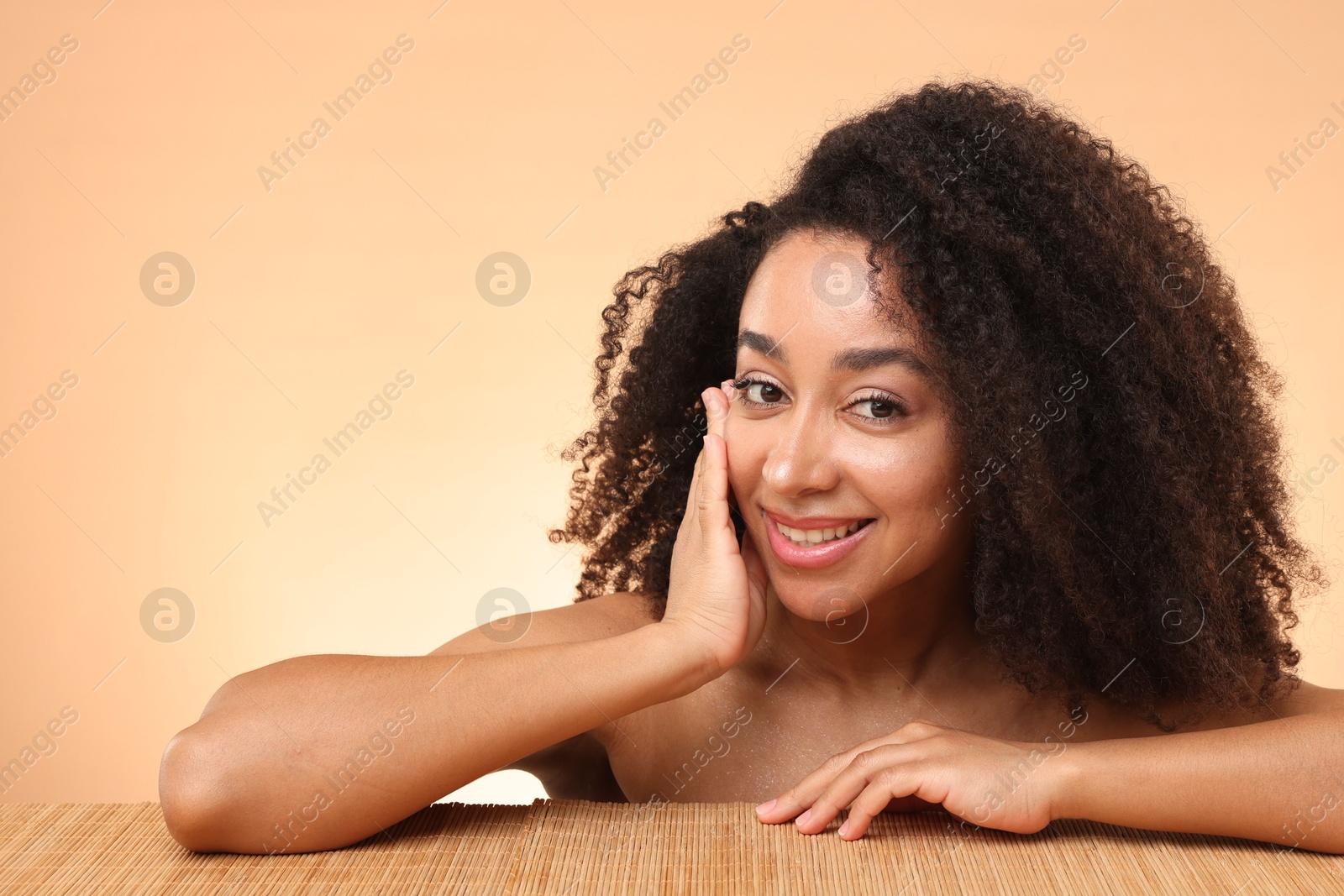 Portrait of beautiful Brazilian woman after spa treatment at bamboo table on beige gradient background Photo of Portrait of beautiful Brazilian woman after spa treatment at bamboo table on beige gradient background