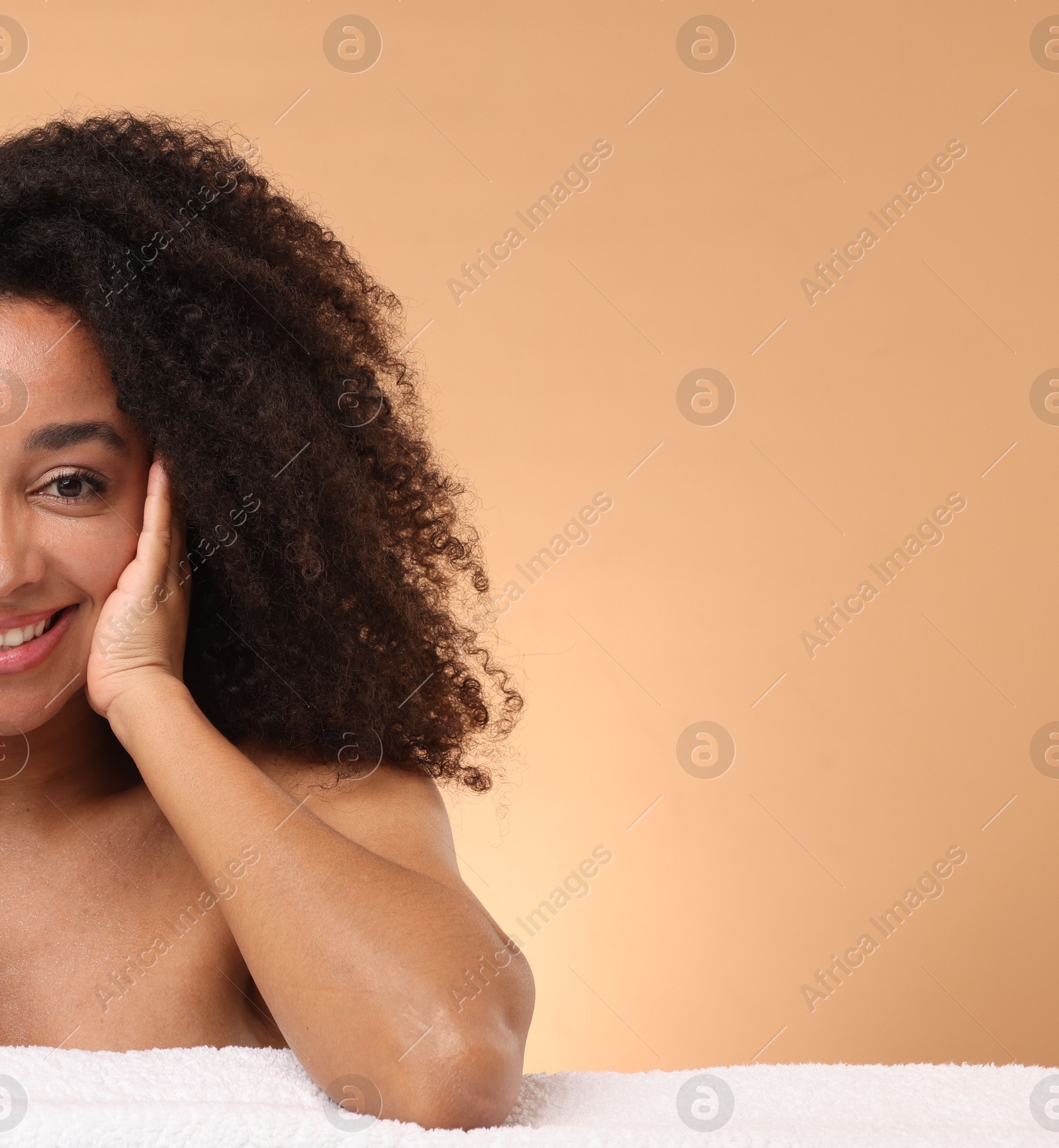 Portrait of beautiful Brazilian woman with towel after spa treatment on beige gradient background. Space for text Photo of Portrait of beautiful Brazilian woman with towel after spa treatment on beige gradient background. Space for text