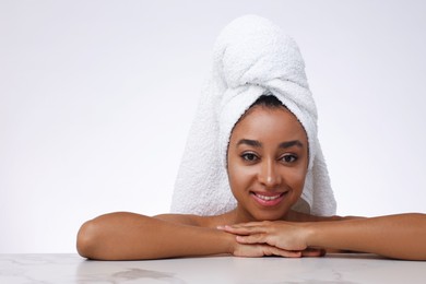 Photo of Portrait of beautiful Brazilian woman after spa treatment at gray marble table on light background