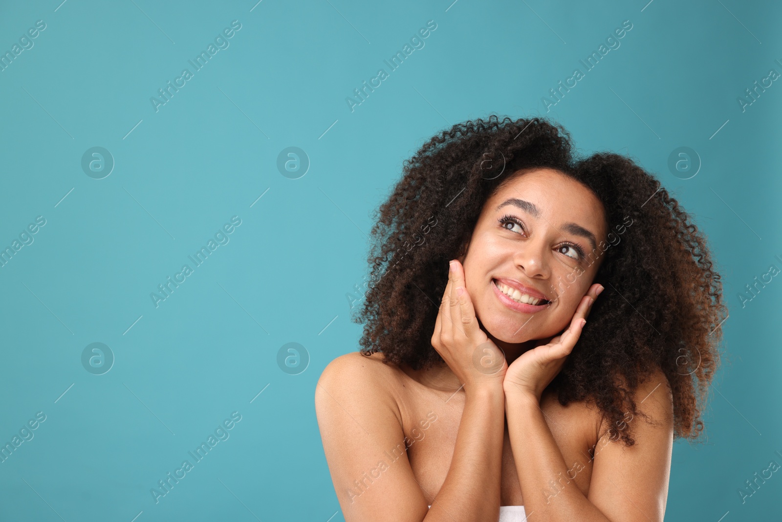 Portrait of beautiful Brazilian woman after spa treatment on light blue background. Space for text Photo of Portrait of beautiful Brazilian woman after spa treatment on light blue background. Space for text