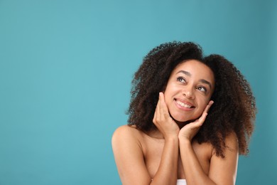 Photo of Portrait of beautiful Brazilian woman after spa treatment on light blue background. Space for text