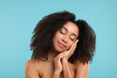 Photo of Portrait of beautiful Brazilian woman after spa treatment on light blue background