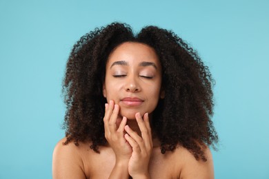 Photo of Portrait of beautiful Brazilian woman after spa treatment on light blue background