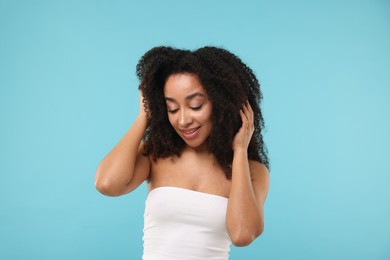 Photo of Portrait of beautiful Brazilian woman after spa treatment on light blue background
