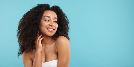 Photo of Portrait of beautiful Brazilian woman after spa treatment on light blue background. Space for text