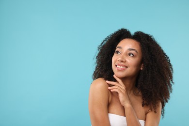 Photo of Portrait of beautiful Brazilian woman after spa treatment on light blue background. Space for text