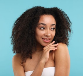 Photo of Portrait of beautiful Brazilian woman after spa treatment on light blue background