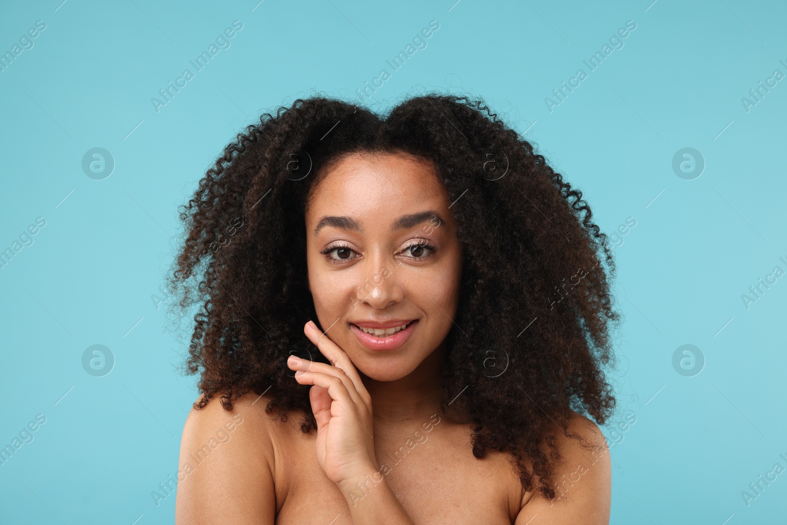 Portrait of beautiful Brazilian woman after spa treatment on light blue background Photo of Portrait of beautiful Brazilian woman after spa treatment on light blue background