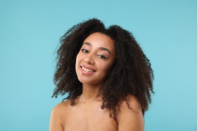 Photo of Portrait of beautiful Brazilian woman after spa treatment on light blue background