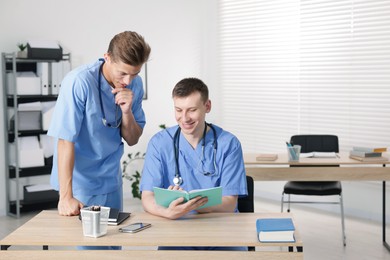 Photo of Medical students in uniforms studying together at university