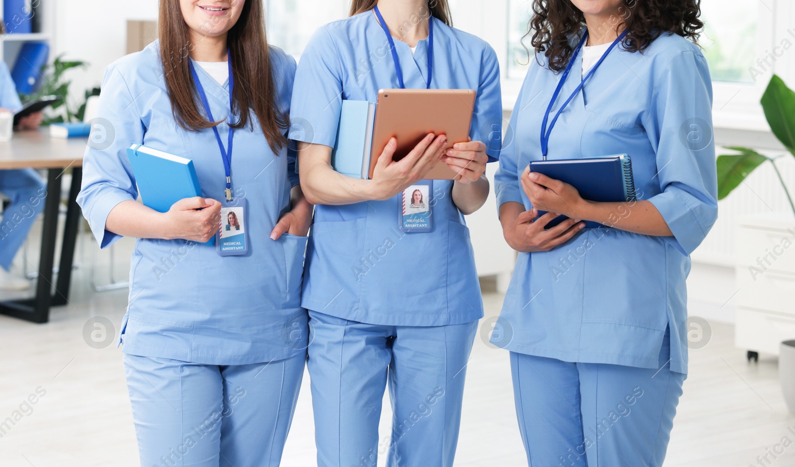 Medical students in uniforms indoors, selective focus Photo of Medical students in uniforms indoors, selective focus
