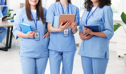 Photo of Medical students in uniforms indoors, selective focus