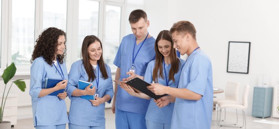 Photo of Group of medical students in uniforms indoors