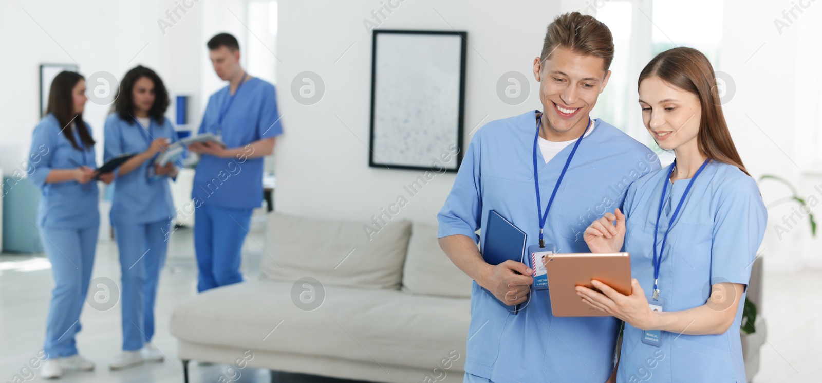 Medical students in uniforms indoors, selective focus Photo of Medical students in uniforms indoors, selective focus
