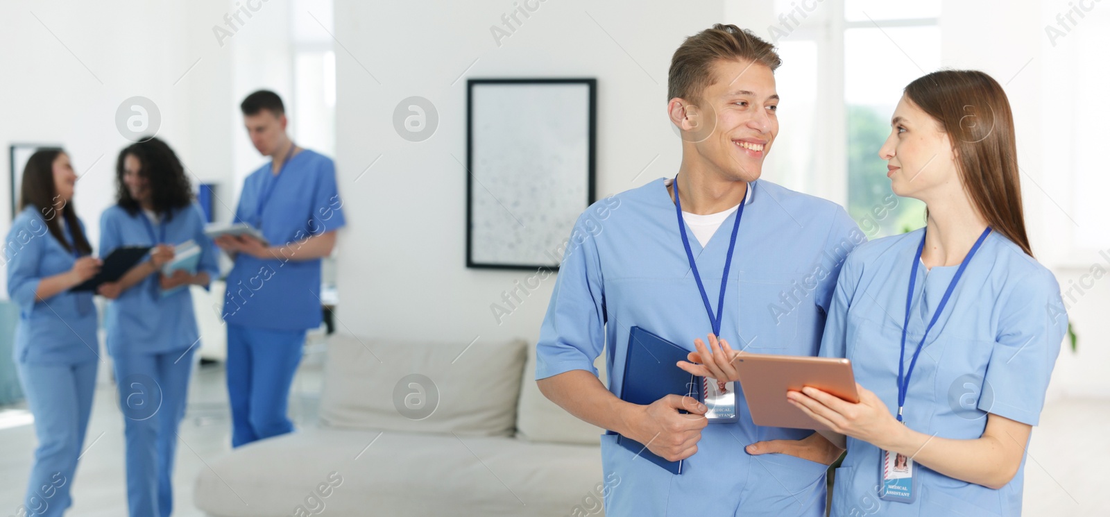 Medical students in uniforms indoors, selective focus Photo of Medical students in uniforms indoors, selective focus
