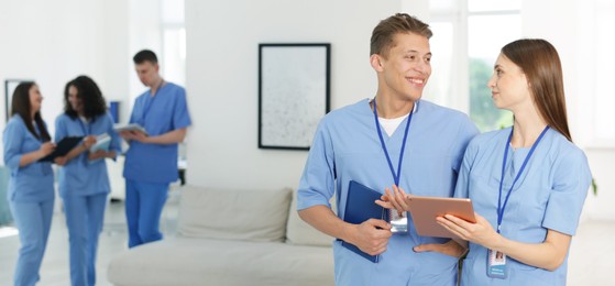 Photo of Medical students in uniforms indoors, selective focus