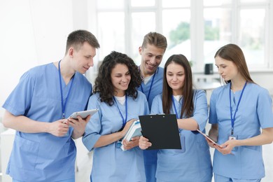 Photo of Group of medical students in uniforms indoors