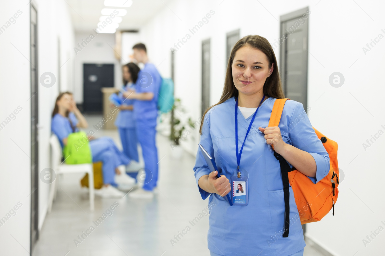 Medical student in uniform with backpack at university, selective focus Photo of Medical student in uniform with backpack at university, selective focus