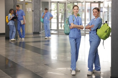 Photo of Medical students in uniforms indoors, selective focus