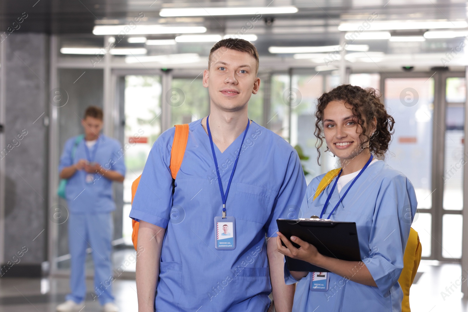 Medical students in uniforms indoors, selective focus Photo of Medical students in uniforms indoors, selective focus
