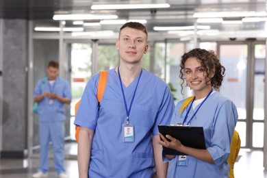 Photo of Medical students in uniforms indoors, selective focus