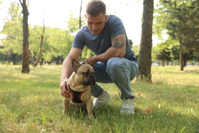 Photo of Man with his cute French bulldog in park