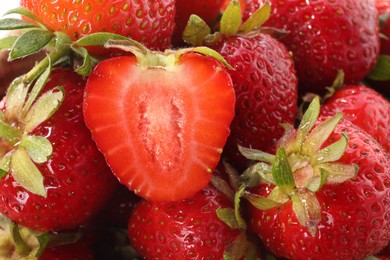 Photo of Whole and cut fresh ripe strawberries as background, closeup