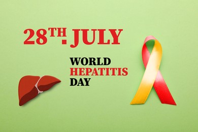 Image of 28th july World Hepatitis Day. Yellow-red awareness ribbon and illustration of liver on light green background, top view