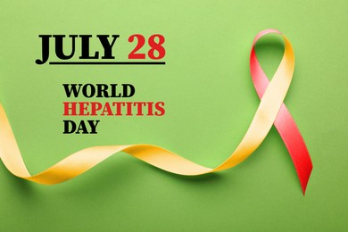 Image of 28th july World Hepatitis Day. Yellow-red awareness ribbon on light green background, top view