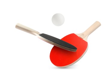 Image of Ping pong rackets and ball in air against white background