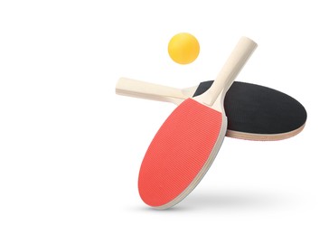 Image of Ping pong rackets and ball in air against white background