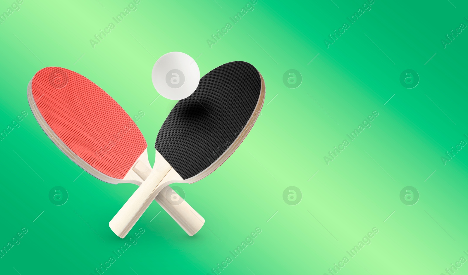 Ping pong rackets and ball in air against green gradient background. Banner design with space for text Image of Ping pong rackets and ball in air against green gradient background. Banner design with space for text