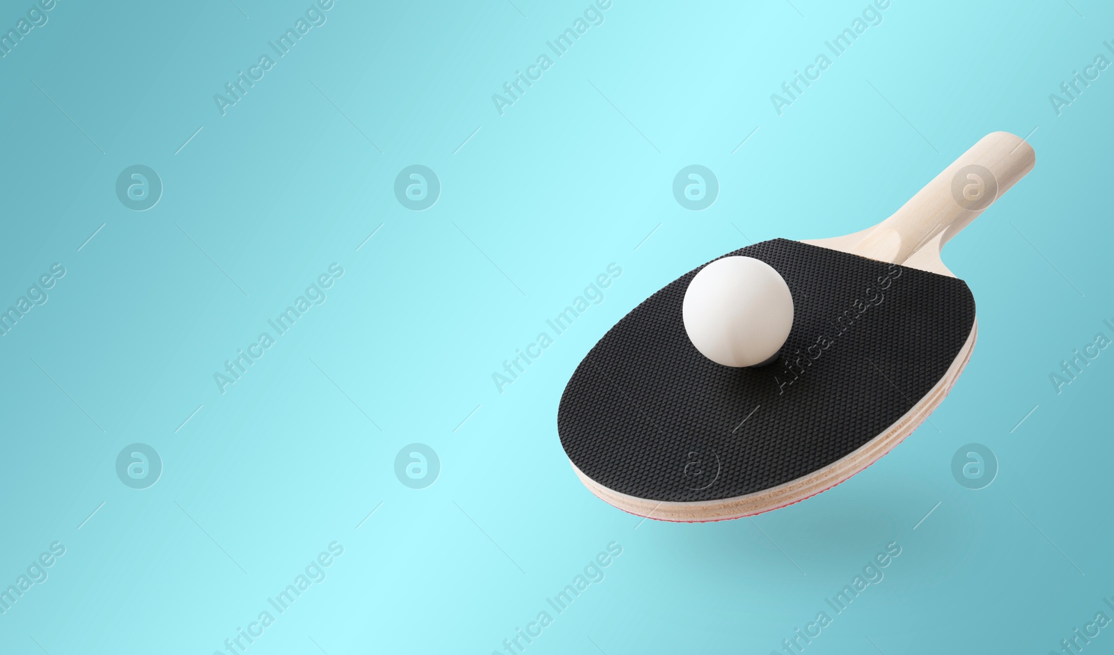 Ping pong racket and ball in air against light blue background. Banner design with space for text Image of Ping pong racket and ball in air against light blue background. Banner design with space for text